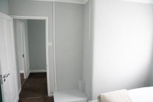a white room with a closet and a door at Modern London House With Free Parking & Family Friendly in Edgware
