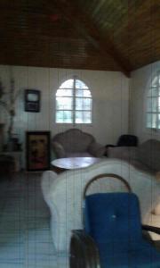 a room with a table and a blue chair at Houria in Oulad Akkou