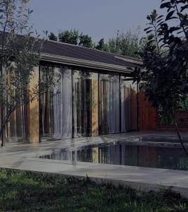 a building with a pool of water in front of it at Vila Eilin - Cozy villa for perfect escapes in Tirana