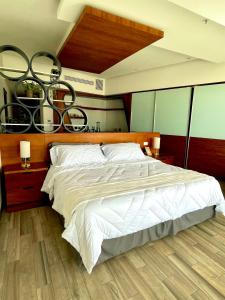 a bedroom with a large bed with a wooden headboard at Hotel Sonata Angelopolis in Lomas de Angelopolis +50 photos