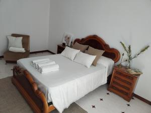 a bedroom with a large bed and a night stand at Casa Pascual in Carnota