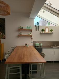 una sala da pranzo con tavolo in legno in cucina di Maison de pêcheur à 900 mètres de la plage de Malo a Dunkerque Altre 19 foto