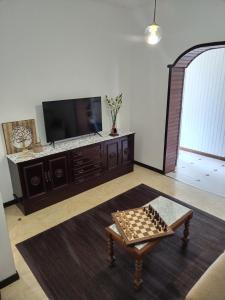 a living room with a chessboard on a table at Casa Pascual in Carnota