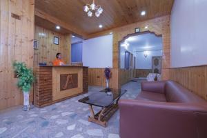 a woman standing at a podium in a room at The Applewood Villa in Manali Romantic Stay in Manāli