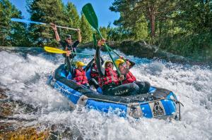 a group of people in a raft on a river at Rio Adventures Rafting Köprülü Kanyon Konaklama in Karabük