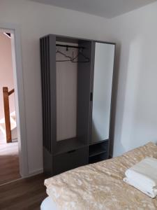 a black cabinet in a room with a bed at Ninas & Andrejs Gästezimmer in Hinterweiler