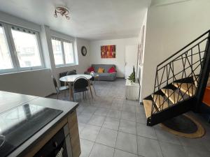 a living room with a kitchen and a dining room at Appart 2 à croix in Croix +21 photos