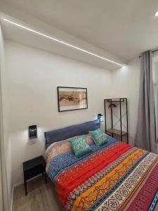a bedroom with a bed with a colorful blanket at Casa Amabile in Rome