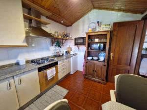 a kitchen with a stove and a counter top at Chousiña in Puentesampayo