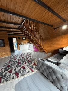 a living room with a couch and a rug at Rio Adventures Rafting Köprülü Kanyon Konaklama in Karabük