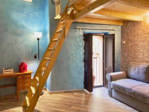 a living room with a wooden staircase and a couch at Poet's rooms in Taormina