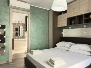 a bedroom with a large bed with towels on it at Poet's rooms in Taormina