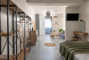 a bedroom with a bed and a living room at Nuovo Suites-Central Stay With Private Parking in Neos Marmaras