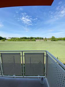 a balcony with a view of a field at Apartament Krakowska - winda, parking in Ostrów Wielkopolski +1 photo