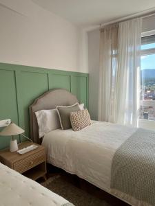 a bedroom with a large bed and a window at O Victoriano in Caldas de Reis