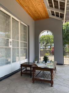 a room with a table and a bench and windows at Hulley Homes- Escape to Beautiful Mountain Views in Umtali
