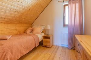 a bedroom with a bed and a window at Osada Izerska in Szklarska Poręba