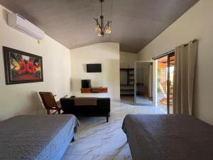 a bedroom with two beds and a living room at Baruch Tropical Ranch in Los Santos