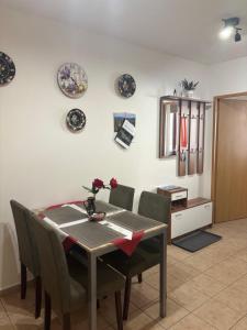 a dining room with a table and chairs and plates on the wall at Apartment Ortler in Banská Štiavnica +5 photos