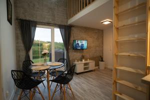 a small dining room with a table and chairs at Bunkier House in Niedźwiada