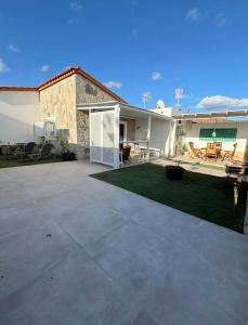 a house with a patio and a yard at Casa Diana in Tarajalejo +33 photos
