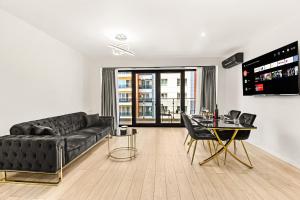 a living room with a black couch and a table at InCity Studio - Near Bucharest Mall, Balcony - RH Living in Bucharest