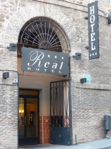 a building with a sign for a local store at Hotel Real De Toledo in Toledo