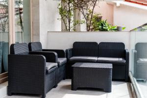 a group of chairs and tables on a patio at Olivia Apartament in Năvodari