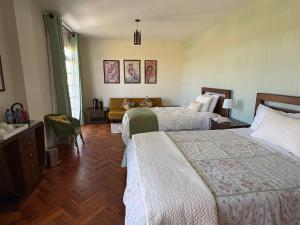 a hotel room with two beds and a couch at Casa Deco Hotel Boutique in Cochabamba +66 photos