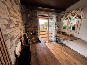a kitchen with a sink and a brick wall at Small house in the nature in Granadilla de Abona