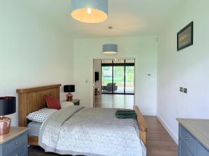 a bedroom with a bed and a desk and a table at Spacious 4 double bed rural escape in Duddlestone