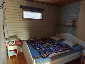 a bedroom with a bed in a room at Ahlaistentupa in Pori +16 photos