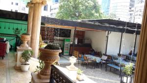 an outdoor patio with a restaurant with tables and chairs at Kk Hotel in Addis Ababa