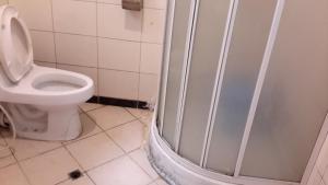 a bathroom with a toilet and a shower stall at Kk Hotel in Addis Ababa +29 photos