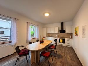 a kitchen with a table and chairs in a room at Ferienwohnung Hubertus in Blankenstein