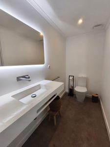 a bathroom with a white sink and a toilet at Cá Por Casa Pico-Faia in Prainha de Baixo +27 photos