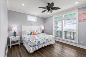 a bedroom with a bed and a ceiling fan at Blessed 4 Shore Beachfront 4B in Gilchrist