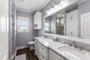 a bathroom with two sinks and a toilet at Blessed 4 Shore Beachfront 4B in Gilchrist +47 photos