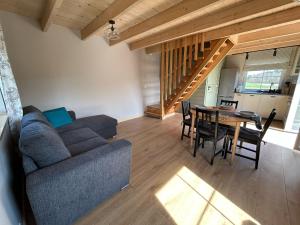 a living room with a couch and a table at Na Domek Windorp in Windorf