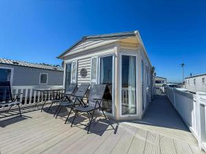 a screened in deck with chairs and a table at 6 Berth Caravan For Hire With Sea Views At Haven Seashore Ref 22087A in Great Yarmouth