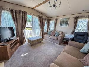 a living room with a couch and a tv at Brilliant Caravan For Hire At Caister Haven Holiday Park In Norfolk Ref 30011H in Great Yarmouth