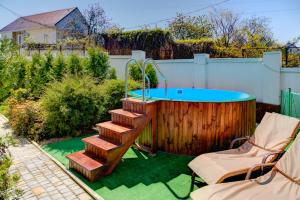 a hot tub and stairs in a backyard with a pool at Apartments Georg-Grad in Odesa