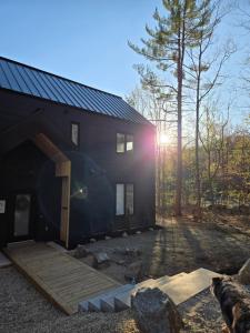 a house with a dog standing in front of it at Armoni Ski & Spa in Cantley