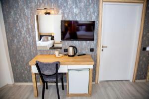 a room with a desk with a television and a bedroom at Bloomtalya Hotel in Antalya +84 photos