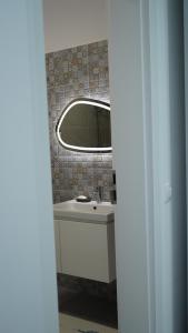 a bathroom with a sink and a mirror at Luxury BROthers' Apartment in Alba Iulia +22 photos