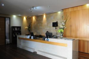 a lobby with a reception counter with flowers on it at Mandurah Quay Resort in Mandurah