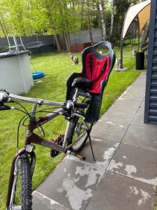 a bicycle with a seat sitting on a sidewalk at Domek Marzenie in Radawa