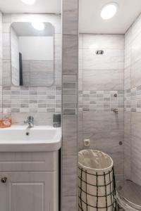 a bathroom with a sink and a shower with a mirror at Studio Invita in Maružini +16 photos