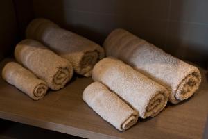 a bunch of rolled up towels sitting on a table at Pļavas in Ainaži