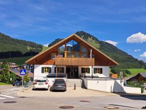 a house with two cars parked in a parking lot at Chalet Zur Rose in Berwang bij de piste in Berwang +47 photos